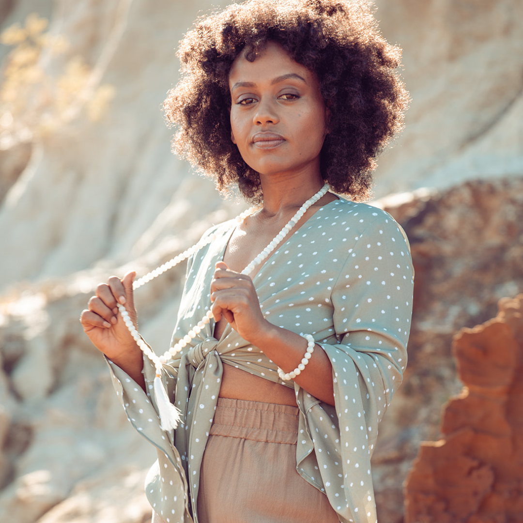 Woman standing in the sunshine wearing New Beginnings - Moonstone Mala Bead Set Ambarya 